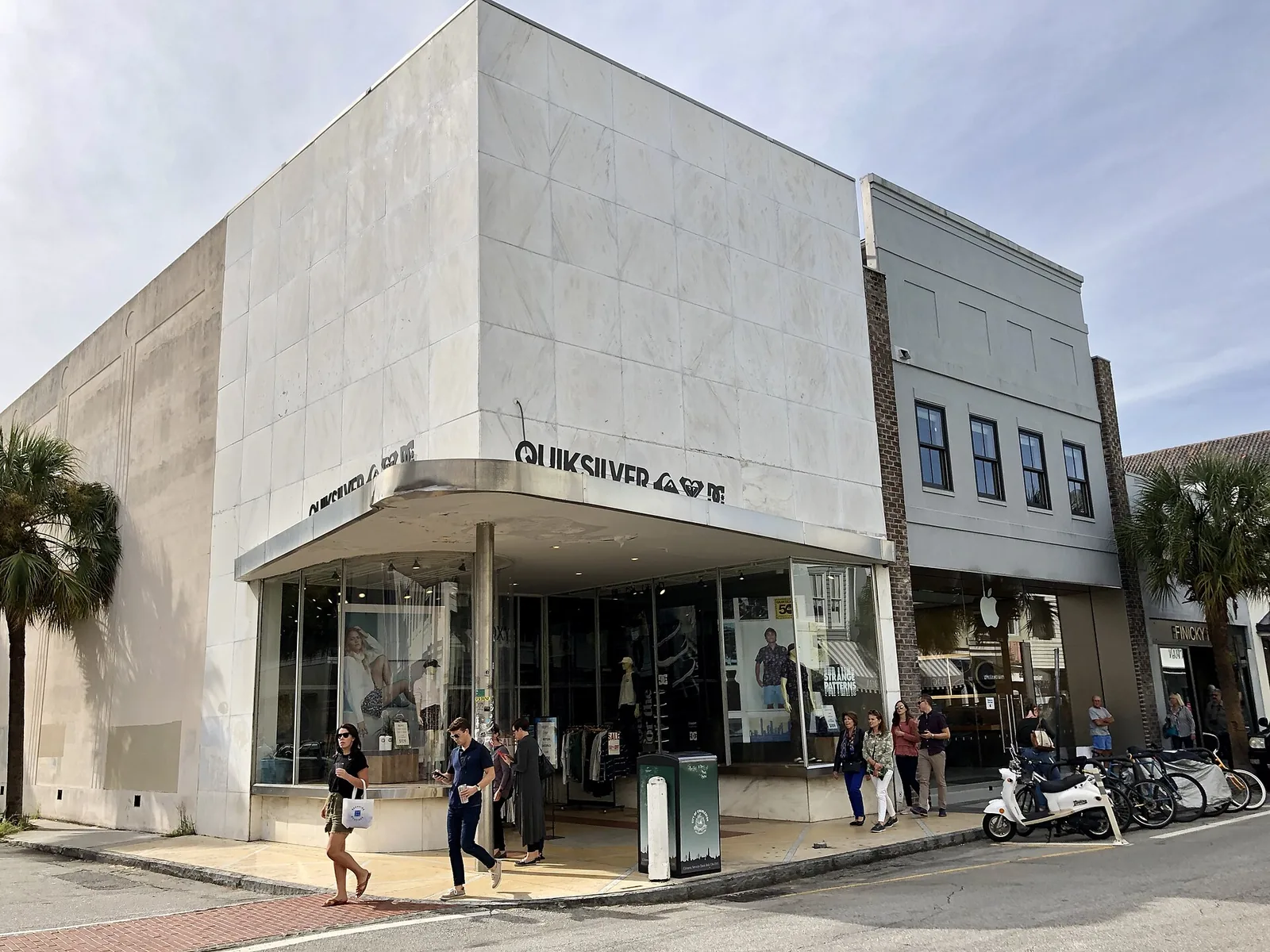 Shoppers walk past stores on King Street in downtown Charleston.