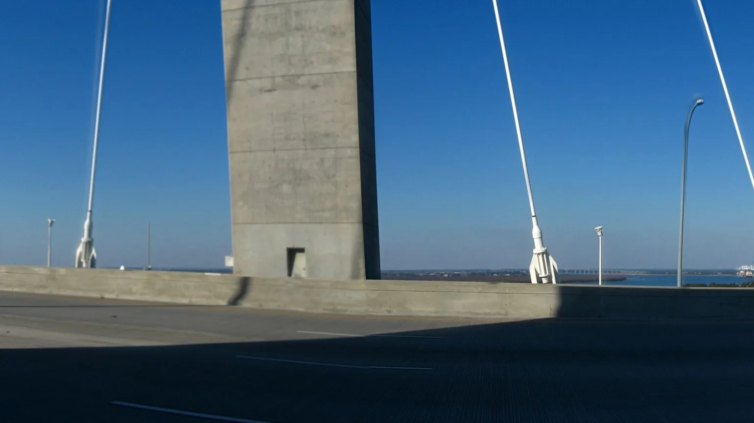 The road deck of the Arthur Ravenel Jr. Bridge beside its eastern tower, part of the Bridge Run course, seen from the pedestrian walkway.