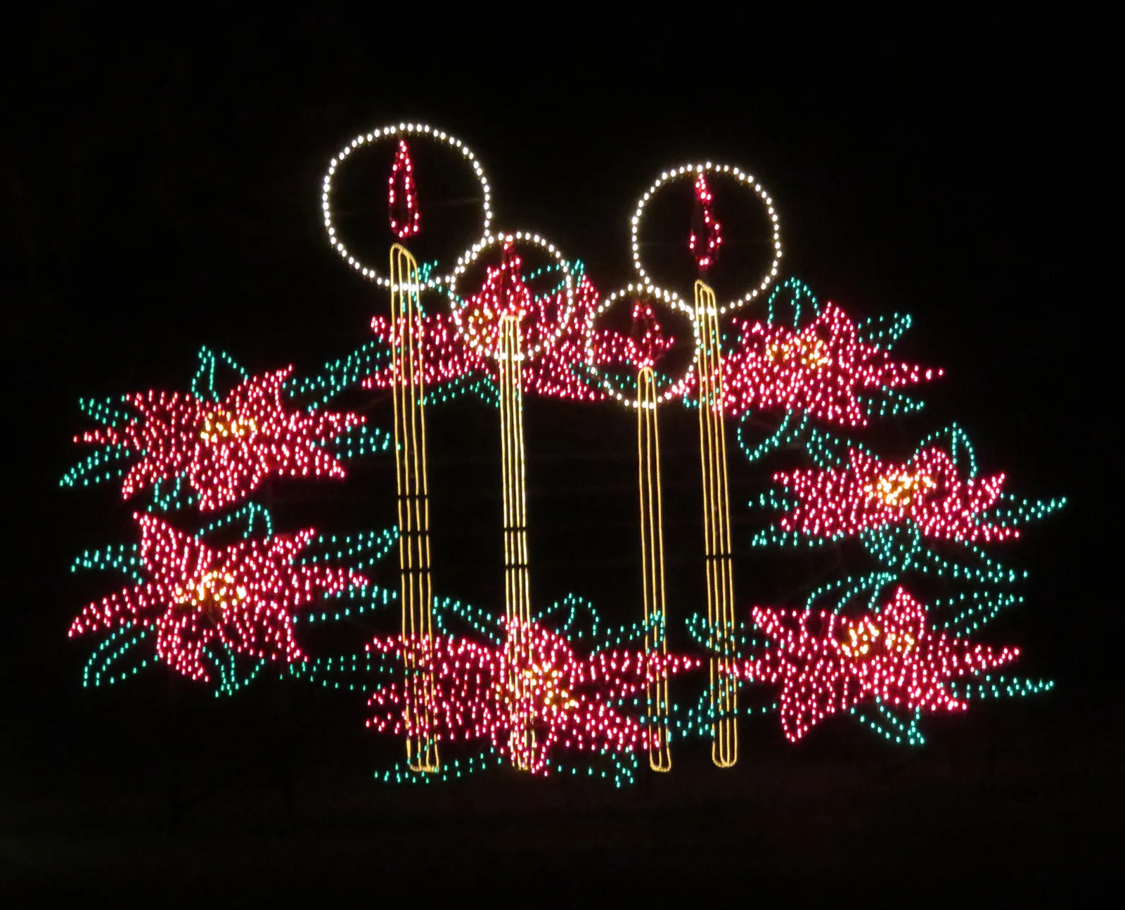 A lighted display of candles and poinsettias at the Holiday Festival of Lights in James Island County Park.