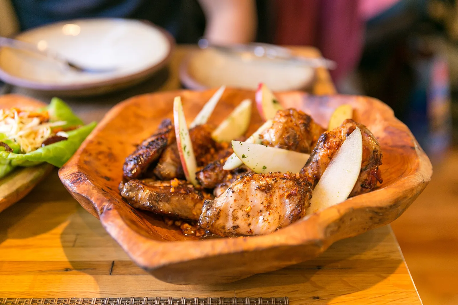 Honey-glazed chicken wings with spiced pecans and apple at Husk in downtown Charleston, a restaurant not on this list.